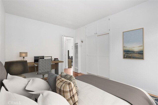 bedroom with hardwood / wood-style flooring and a closet