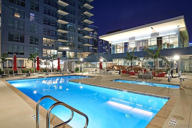 pool at twilight with a patio