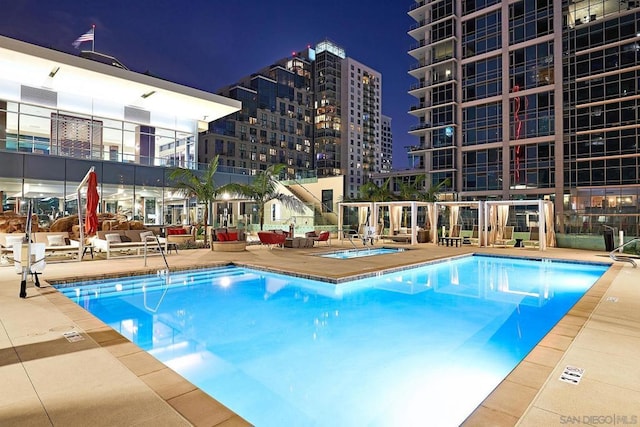 view of pool with a community hot tub and a patio