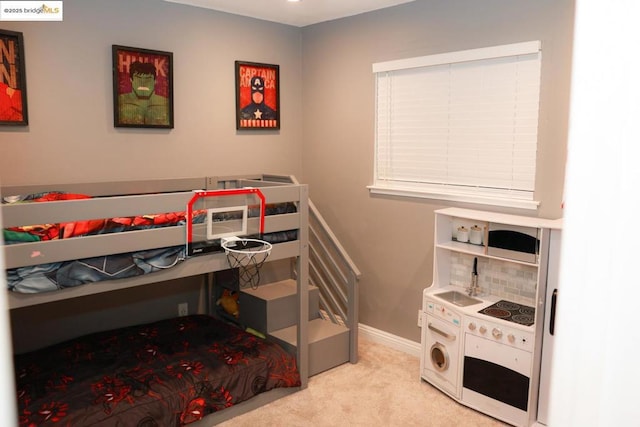 bedroom featuring light carpet