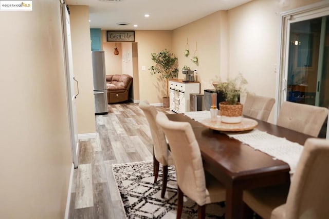 dining space featuring light wood-type flooring