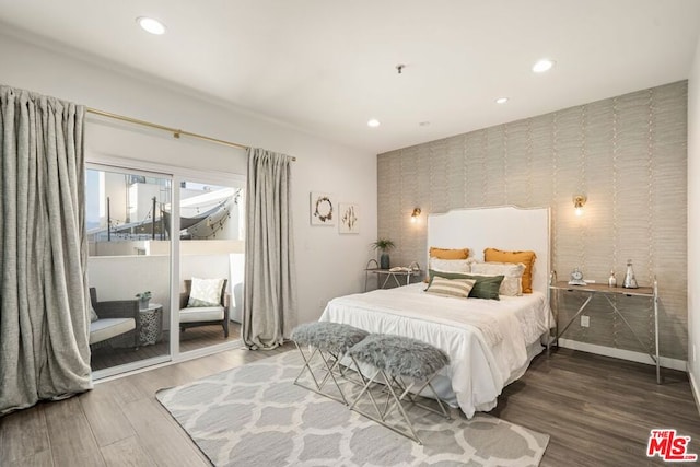 bedroom featuring hardwood / wood-style flooring and access to outside