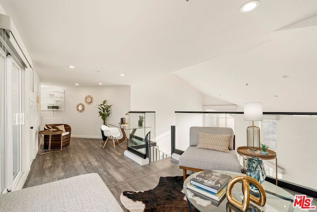 sitting room with hardwood / wood-style flooring and vaulted ceiling