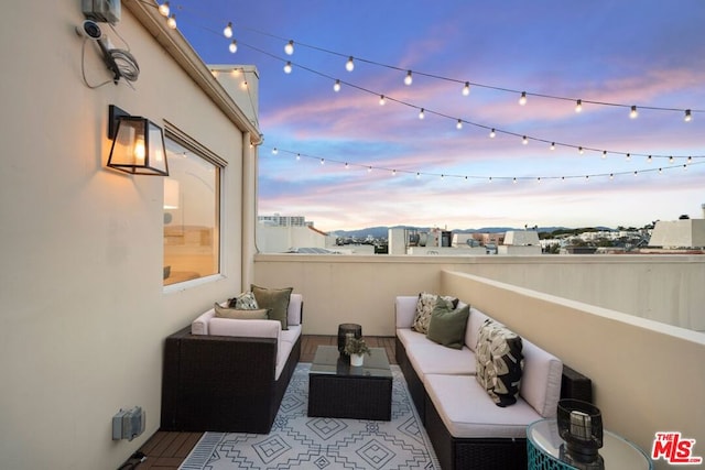 balcony at dusk with an outdoor living space