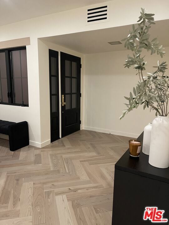 foyer featuring light parquet flooring