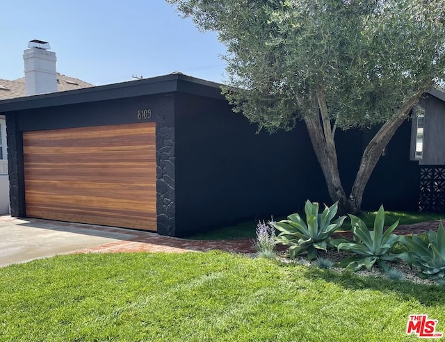 garage featuring a yard