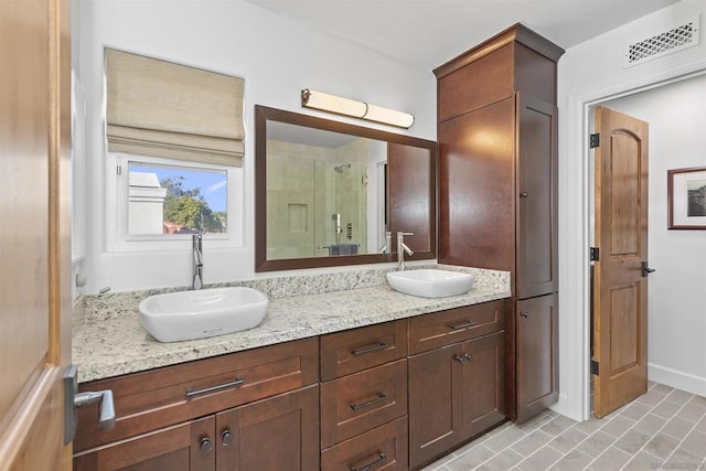 bathroom featuring vanity and a shower with shower door