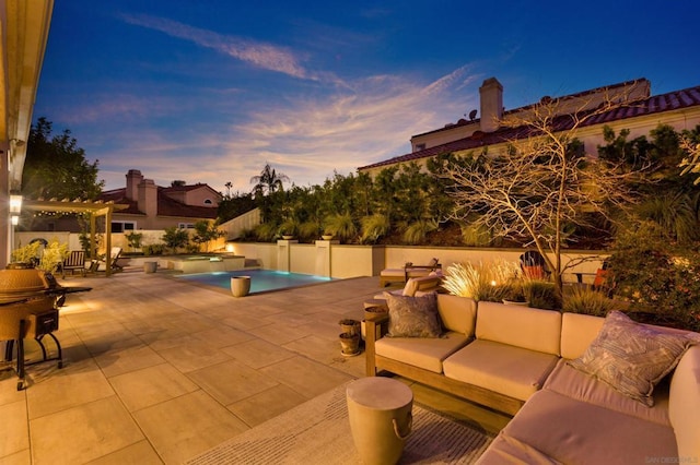 pool at dusk featuring outdoor lounge area and a patio