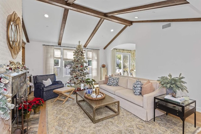 living room featuring hardwood / wood-style flooring and vaulted ceiling with beams