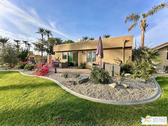 back of house featuring an outdoor hangout area, a patio area, and a lawn