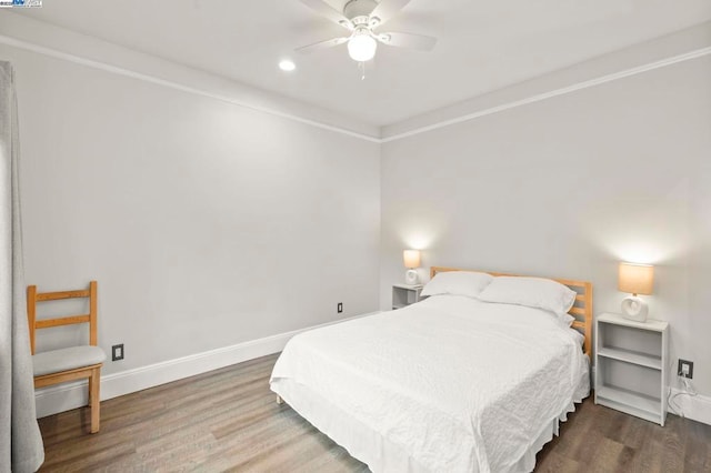 bedroom with dark hardwood / wood-style floors and ceiling fan