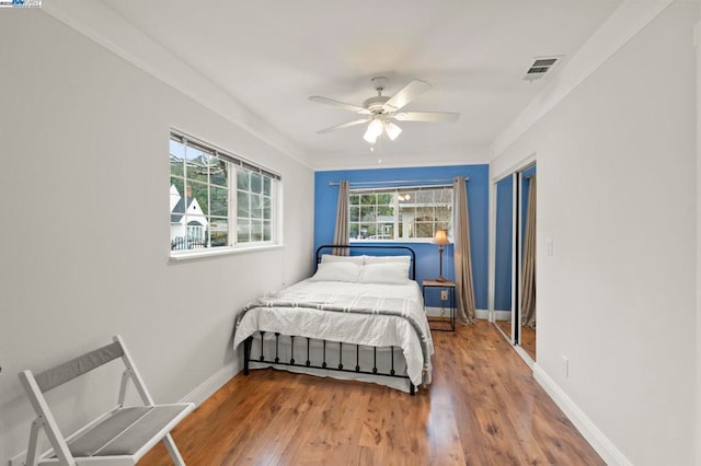 bedroom featuring hardwood / wood-style flooring and ceiling fan