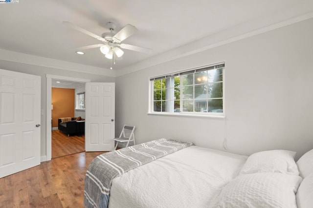 bedroom with hardwood / wood-style floors and ceiling fan