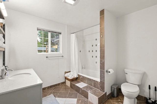 full bathroom featuring shower / tub combo, vanity, and toilet