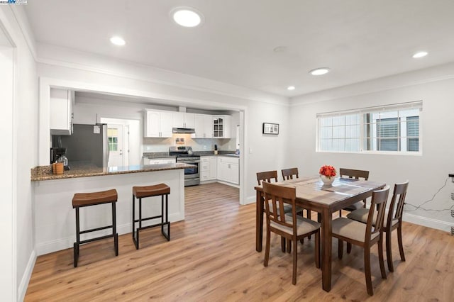 dining area featuring a healthy amount of sunlight and light wood-type flooring