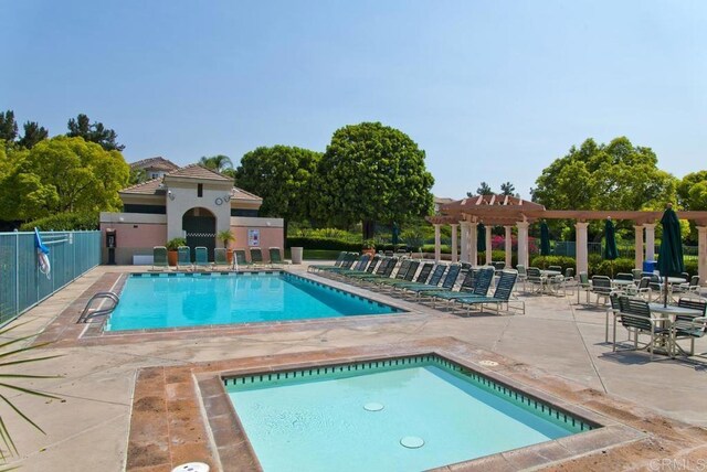 pool featuring a patio, a community hot tub, fence, and a pergola