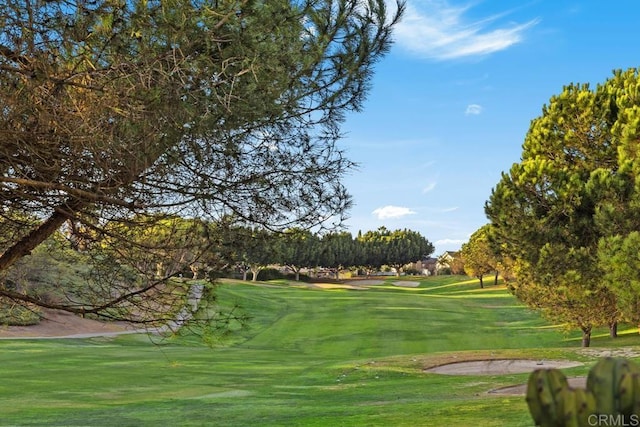 view of property's community featuring a yard and golf course view