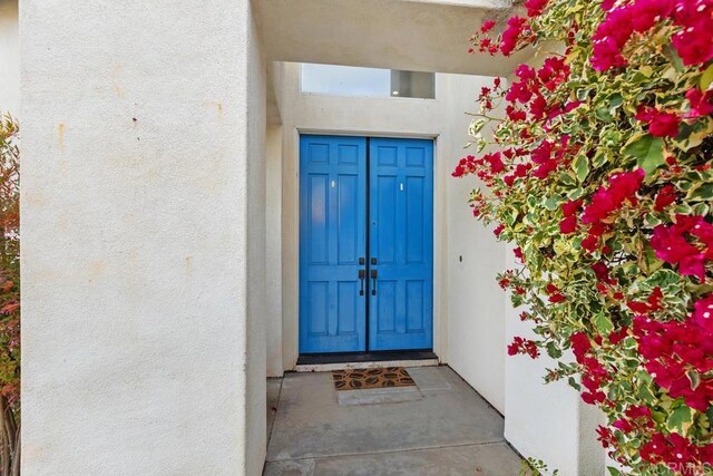 property entrance with stucco siding