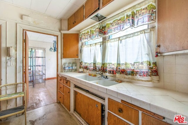 kitchen with tasteful backsplash, sink, and tile countertops