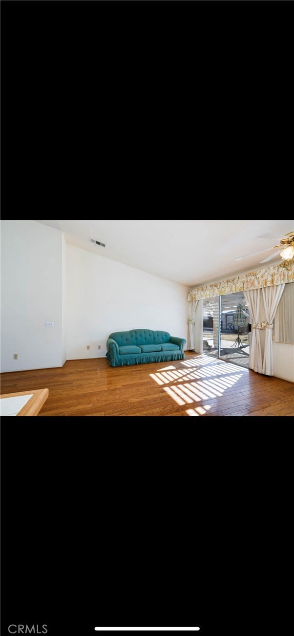 interior space with hardwood / wood-style floors and ceiling fan