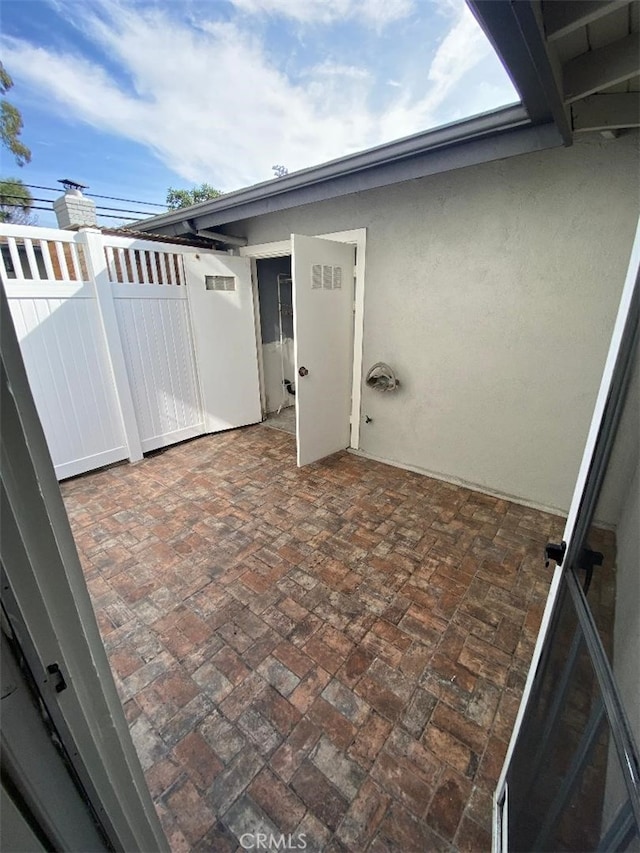 view of patio featuring a gate and fence