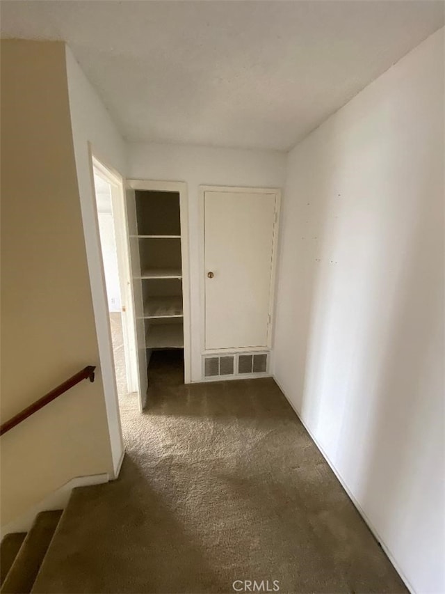 interior space with dark colored carpet and visible vents