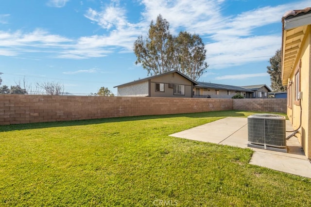 view of yard featuring central AC and a patio area