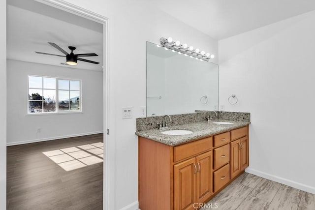 bathroom featuring hardwood / wood-style flooring, ceiling fan, and vanity