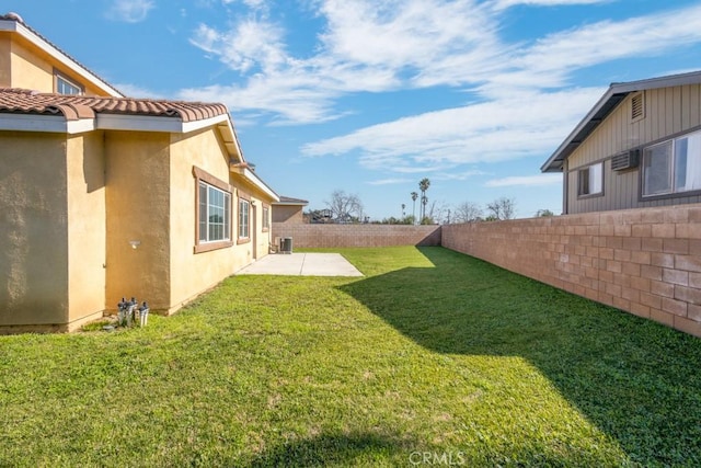 view of yard with central AC and a patio area