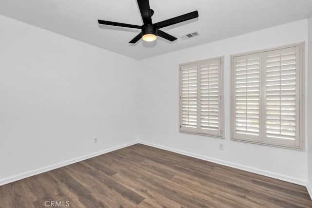 unfurnished room featuring dark wood-type flooring and ceiling fan