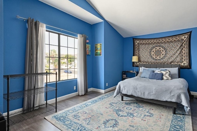 bedroom featuring dark hardwood / wood-style flooring and vaulted ceiling