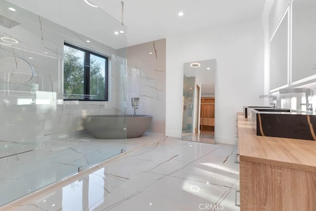 bathroom with vanity and a bath