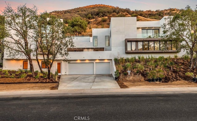 modern home featuring a garage and a mountain view