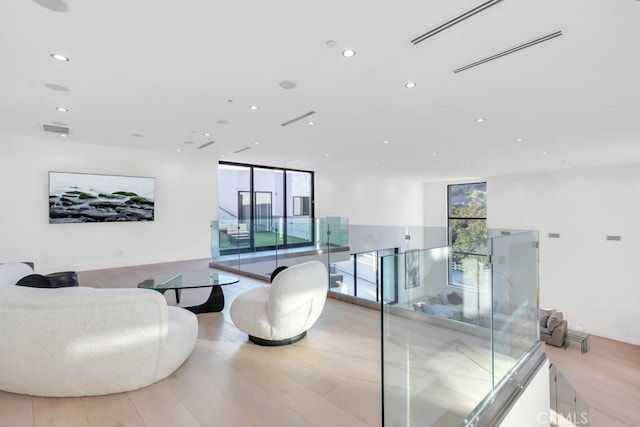 interior space featuring light hardwood / wood-style floors and a wall of windows