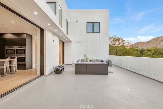 view of patio / terrace with a mountain view and outdoor lounge area