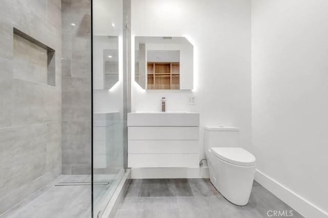 bathroom with vanity, toilet, and tiled shower