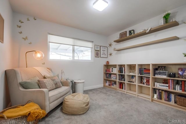 sitting room featuring light colored carpet