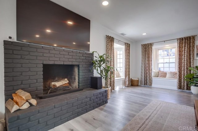 unfurnished living room featuring hardwood / wood-style flooring and a fireplace