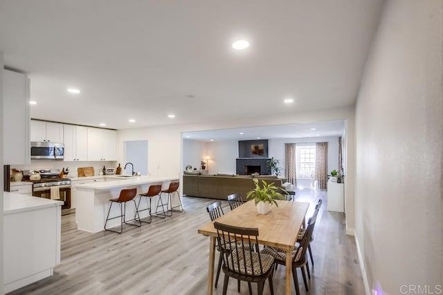 dining space featuring light wood-type flooring