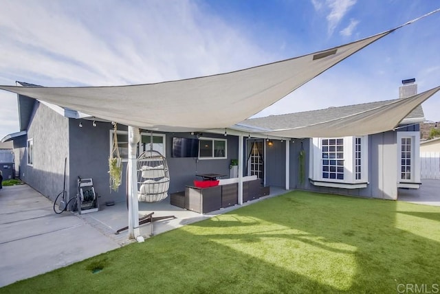 back of property with a yard, outdoor lounge area, and a patio