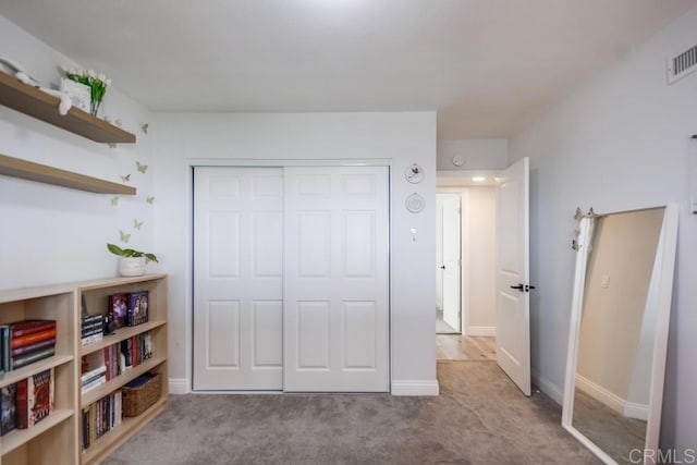 bedroom with light colored carpet and a closet