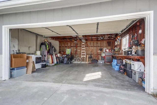 garage featuring independent washer and dryer and a workshop area