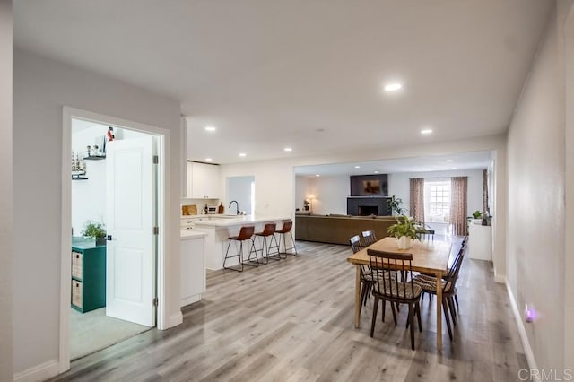 dining area featuring sink and light hardwood / wood-style flooring