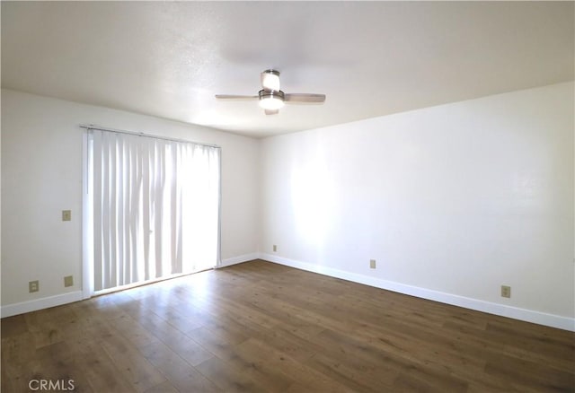 empty room with dark hardwood / wood-style flooring and ceiling fan