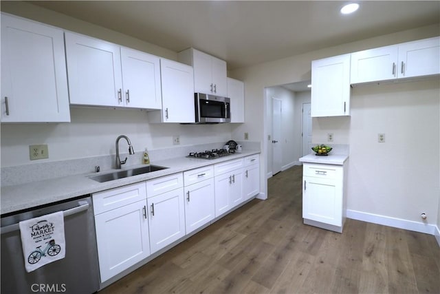 kitchen featuring white cabinetry, sink, and appliances with stainless steel finishes