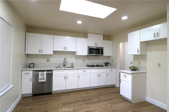 kitchen featuring white cabinetry, sink, stainless steel appliances, and dark hardwood / wood-style floors