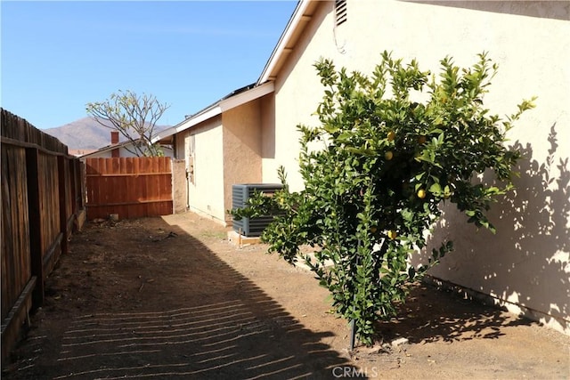 view of side of home featuring a mountain view and central air condition unit