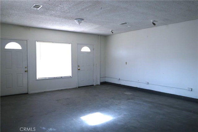 entryway with a textured ceiling