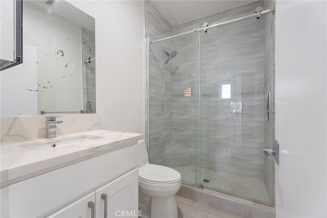 bathroom featuring vanity, an enclosed shower, tile patterned floors, and toilet