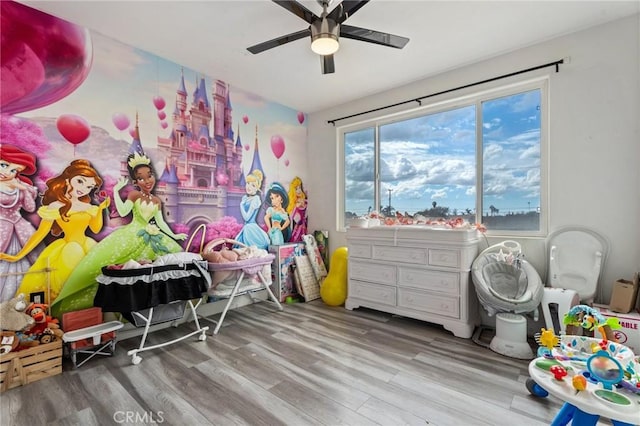 playroom featuring hardwood / wood-style flooring and ceiling fan